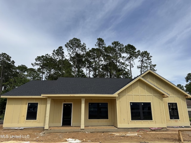 832 Combel St, Waveland, MS 39576 - view of front of house with board and batten siding and a shingled roof