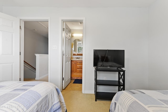 bedroom with light carpet and a sink