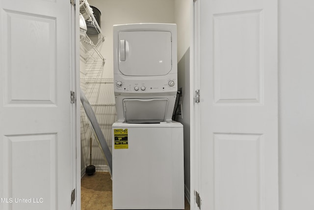 washroom with stacked washer and dryer and laundry area