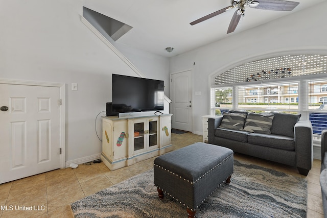 living room with ceiling fan, light tile patterned flooring, and baseboards