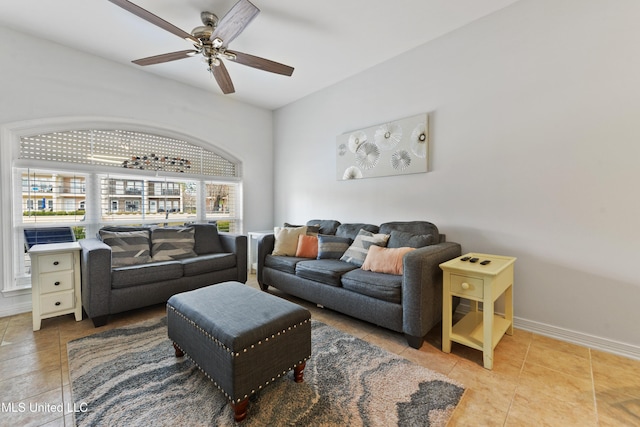 tiled living room with baseboards and a ceiling fan