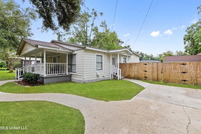 exterior space with covered porch and a front yard