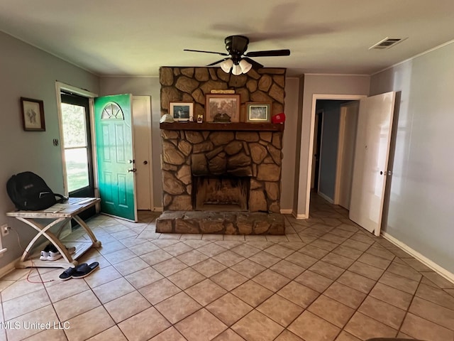 206 Shields Ave, Pelahatchie, MS 39145 - unfurnished living room with a ceiling fan, light tile patterned floors, a stone fireplace, ornamental molding, and baseboards