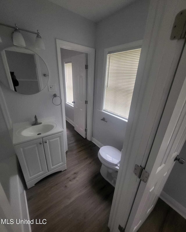 4222 Chennault Ave, Jackson, MS 39209 - bathroom featuring vanity, baseboards, wood finished floors, and toilet