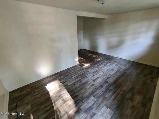unfurnished room with dark hardwood / wood-style floors