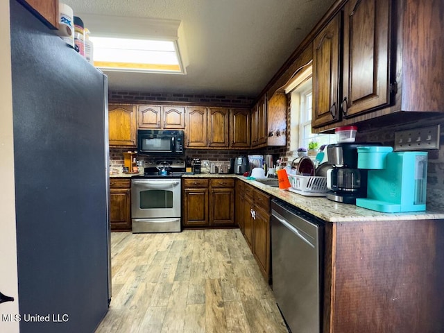 kitchen featuring appliances with stainless steel finishes and light wood-type flooring