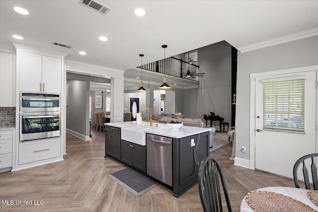 136 S Cypress Lake Blvd, Madison, MS 39110 - kitchen featuring appliances with stainless steel finishes, open floor plan, light countertops, ornamental molding, and white cabinets