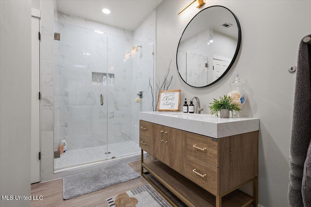 136 S Cypress Lake Blvd, Madison, MS 39110 - bathroom featuring wood finished floors, vanity, and a marble finish shower