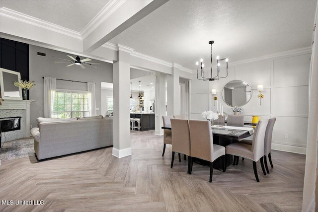 136 S Cypress Lake Blvd, Madison, MS 39110 - dining area with a chandelier, a premium fireplace, ornamental molding, a ceiling fan, and a textured ceiling