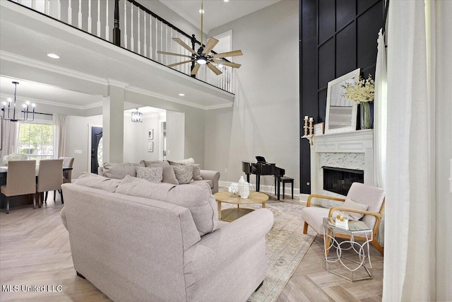 136 S Cypress Lake Blvd, Madison, MS 39110 - living room featuring ceiling fan, a fireplace, a chandelier, a high ceiling, and ornamental molding
