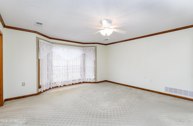 unfurnished room with crown molding, carpet, and ceiling fan