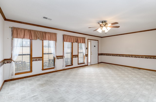 carpeted spare room featuring ornamental molding and ceiling fan