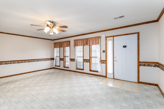 carpeted spare room with ornamental molding, a textured ceiling, and ceiling fan