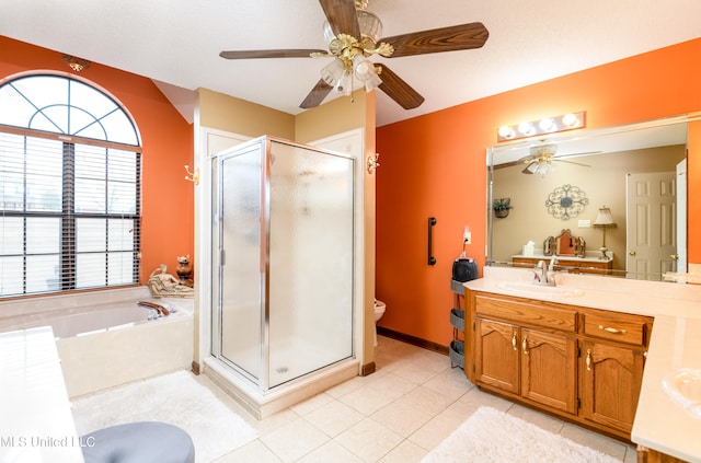 full bathroom featuring vanity, toilet, separate shower and tub, and ceiling fan