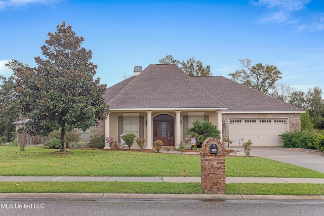 view of front of home with a front lawn and a garage