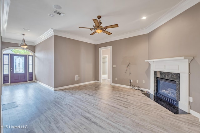 136 Sea Oaks Blvd, Long Beach, MS 39560 - unfurnished living room featuring wood finished floors, crown molding, a ceiling fan, a high end fireplace, and recessed lighting
