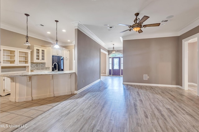 136 Sea Oaks Blvd, Long Beach, MS 39560 - kitchen with a ceiling fan, glass insert cabinets, white cabinets, light wood-style floors, and crown molding