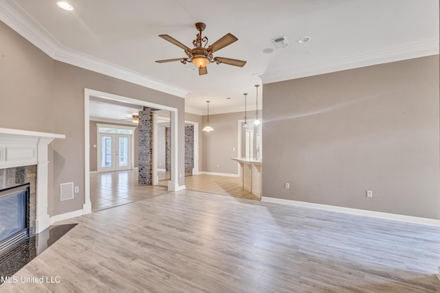 136 Sea Oaks Blvd, Long Beach, MS 39560 - unfurnished living room featuring a ceiling fan, a high end fireplace, ornamental molding, light wood finished floors, and french doors