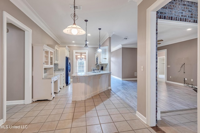 136 Sea Oaks Blvd, Long Beach, MS 39560 - kitchen with glass insert cabinets, white cabinetry, ornamental molding, decorative backsplash, and light tile patterned floors