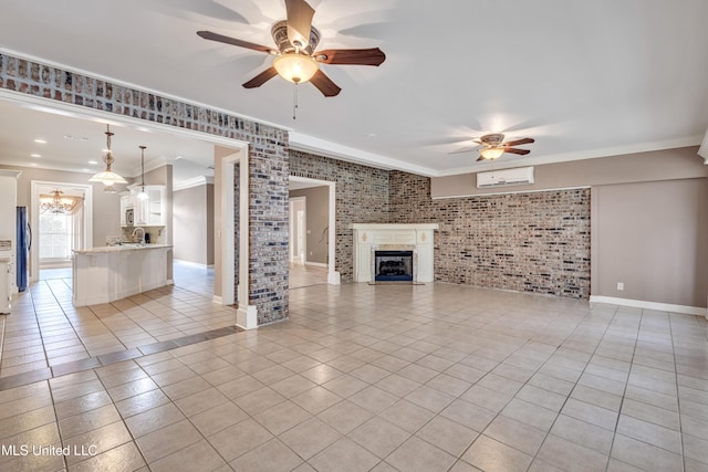 unfurnished living room with ceiling fan, brick wall, a wall unit AC, crown molding, and light tile patterned floors