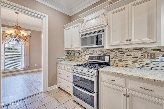 136 Sea Oaks Blvd, Long Beach, MS 39560 - kitchen featuring stainless steel appliances, ornamental molding, a chandelier, backsplash, and white cabinetry