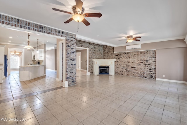 136 Sea Oaks Blvd, Long Beach, MS 39560 - unfurnished living room with ceiling fan, brick wall, crown molding, light tile patterned floors, and a wall mounted air conditioner