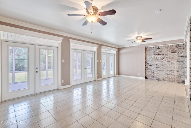 136 Sea Oaks Blvd, Long Beach, MS 39560 - spare room featuring french doors, ornamental molding, ceiling fan, brick wall, and light tile patterned floors