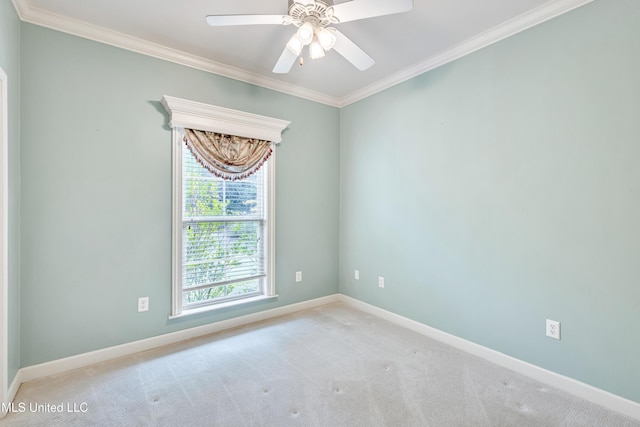 carpeted spare room featuring ceiling fan and crown molding