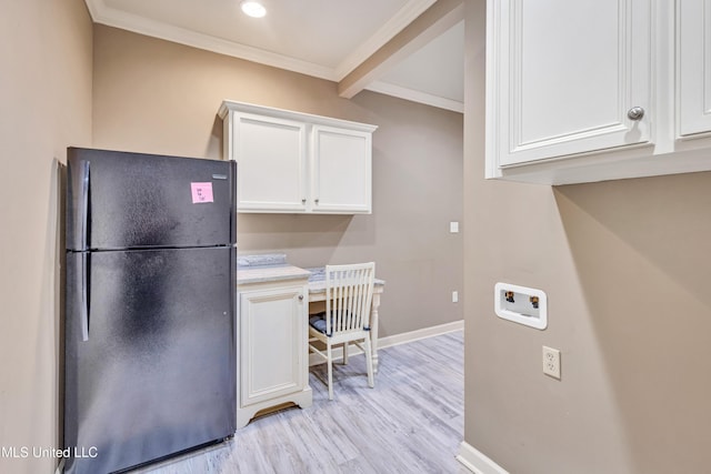 136 Sea Oaks Blvd, Long Beach, MS 39560 - kitchen with freestanding refrigerator, light wood-style flooring, ornamental molding, white cabinetry, and light countertops
