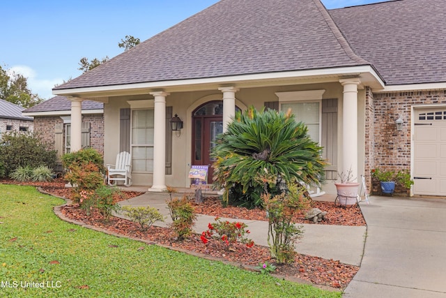 136 Sea Oaks Blvd, Long Beach, MS 39560 - view of front of property featuring roof with shingles, brick siding, an attached garage, a porch, and a front lawn
