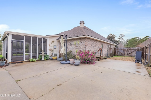 136 Sea Oaks Blvd, Long Beach, MS 39560 - rear view of property featuring a patio area, a sunroom, a fenced backyard, and a chimney