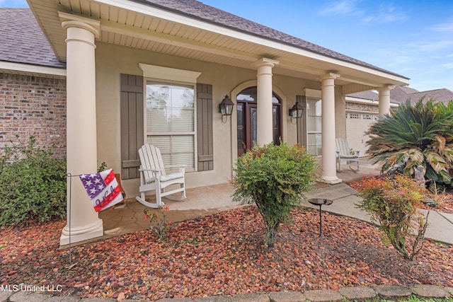 property entrance with covered porch and a garage