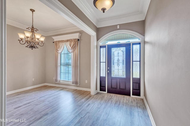 foyer entrance featuring a chandelier, crown molding, and light hardwood / wood-style flooring