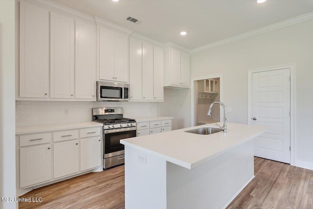 421 Baleigh Way, Canton, MS 39046 - kitchen featuring stainless steel appliances, a sink, ornamental molding, light wood-type flooring, and decorative backsplash