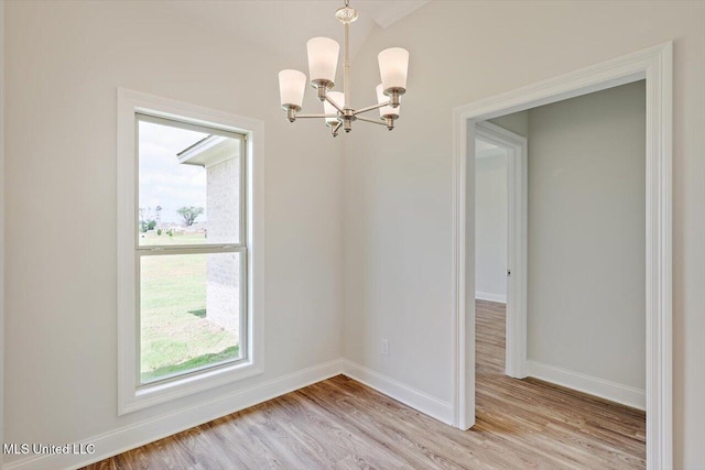 421 Baleigh Way, Canton, MS 39046 - unfurnished dining area featuring a chandelier, healthy amount of natural light, light wood-style floors, and baseboards