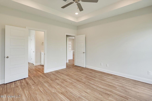 421 Baleigh Way, Canton, MS 39046 - unfurnished bedroom with light wood-style flooring, baseboards, recessed lighting, a raised ceiling, and a ceiling fan