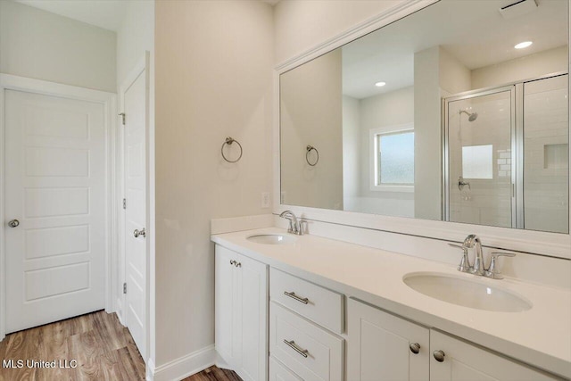 421 Baleigh Way, Canton, MS 39046 - bathroom with a stall shower, wood finished floors, and double vanity