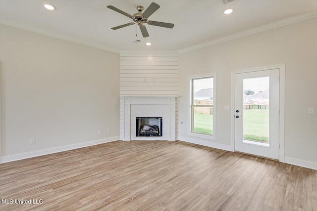 421 Baleigh Way, Canton, MS 39046 - unfurnished living room with light wood-style flooring, a brick fireplace, crown molding, a ceiling fan, and baseboards