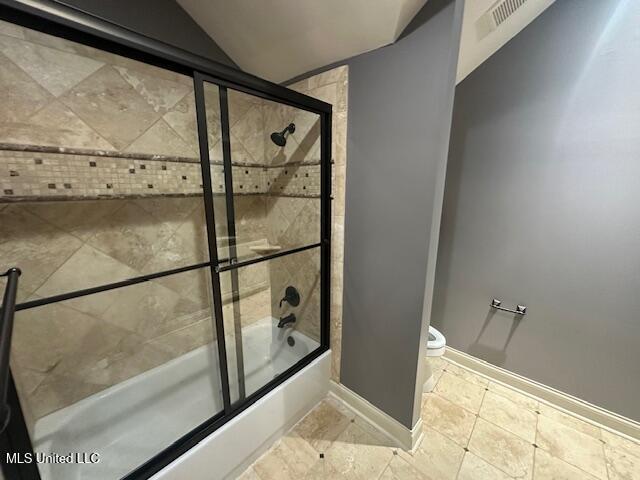 113 Hastings Ave, Brandon, MS 39042 - bathroom with enclosed tub / shower combo, baseboards, lofted ceiling, and toilet