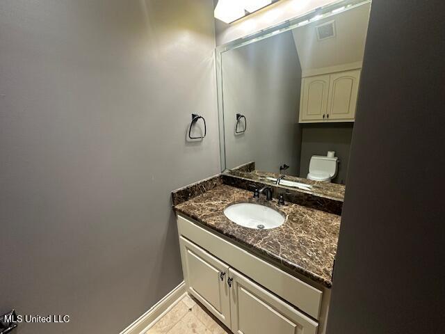 113 Hastings Ave, Brandon, MS 39042 - half bath featuring vanity, tile patterned flooring, baseboards, and toilet