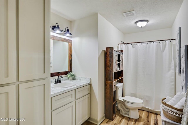 3341 Simpson Highway 13, Mendenhall, MS 39114 - bathroom with vanity, wood finished floors, toilet, a shower with shower curtain, and a textured ceiling
