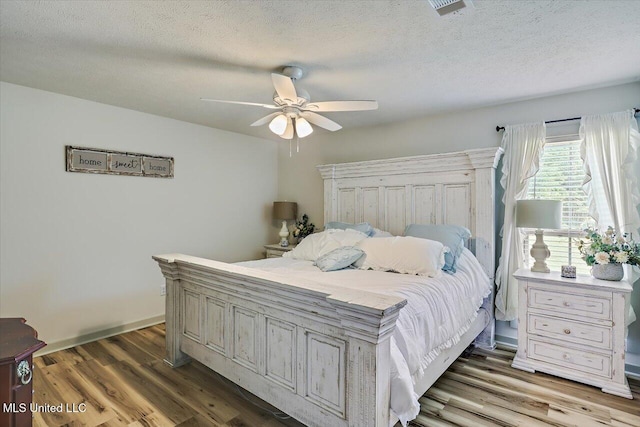 3341 Simpson Highway 13, Mendenhall, MS 39114 - bedroom with a textured ceiling, wood finished floors, a ceiling fan, and baseboards