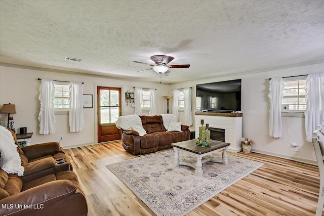 3341 Simpson Highway 13, Mendenhall, MS 39114 - living area with plenty of natural light, wood finished floors, a ceiling fan, and a textured ceiling