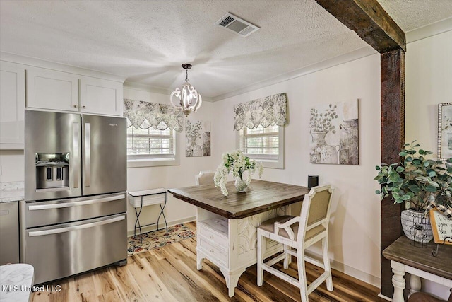 3341 Simpson Highway 13, Mendenhall, MS 39114 - dining area with a textured ceiling, light wood finished floors, a chandelier, and baseboards