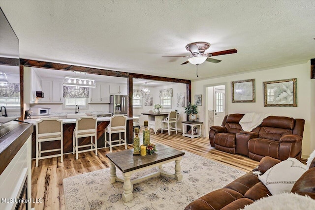 3341 Simpson Highway 13, Mendenhall, MS 39114 - living area featuring a textured ceiling, light wood-type flooring, and a ceiling fan