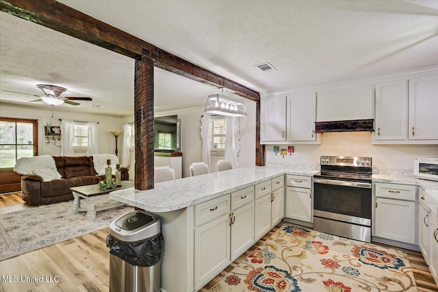 3341 Simpson Highway 13, Mendenhall, MS 39114 - kitchen with stainless steel electric stove, a peninsula, a textured ceiling, white microwave, and open floor plan