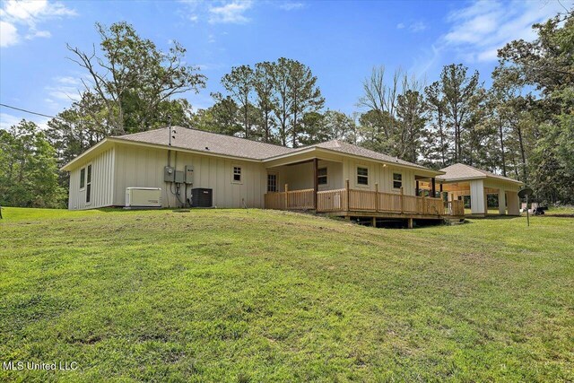 3341 Simpson Highway 13, Mendenhall, MS 39114 - rear view of house with board and batten siding, central AC unit, a lawn, and a wooden deck
