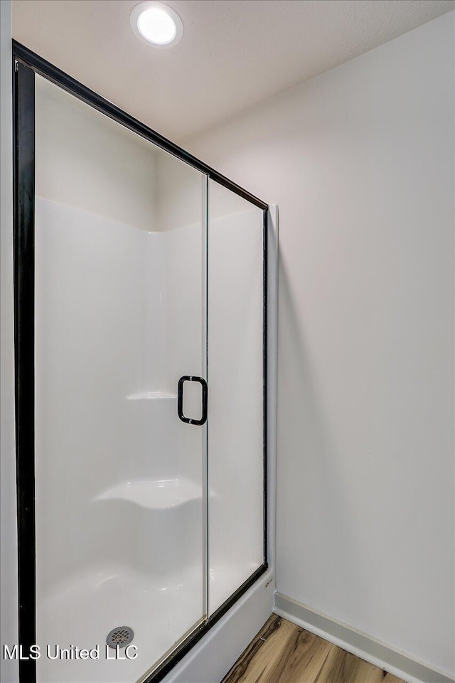 3341 Simpson Highway 13, Mendenhall, MS 39114 - full bathroom with wood finished floors, a stall shower, and baseboards