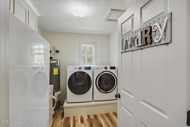 3341 Simpson Highway 13, Mendenhall, MS 39114 - washroom featuring washing machine and clothes dryer, light wood finished floors, a textured ceiling, and water heater