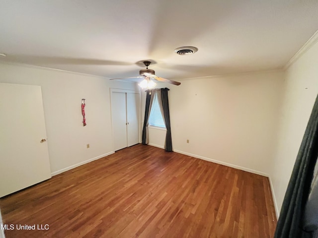 unfurnished room featuring crown molding and wood-type flooring